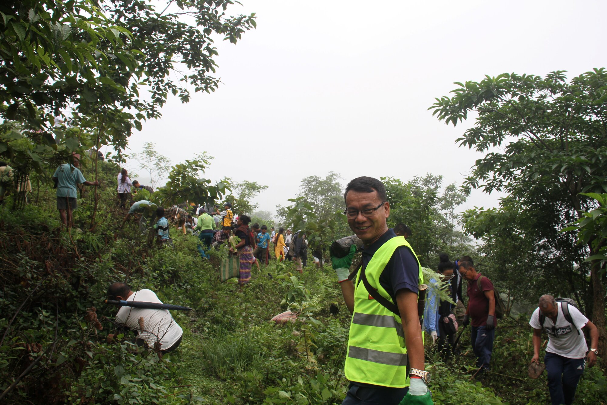 A volunteer planting a fruit tree sapling on Saturday morning.